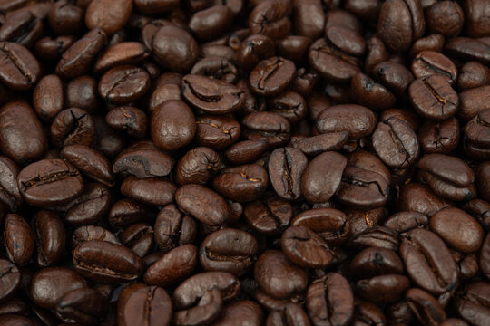 Coffee bean background. Roasted coffee beans on the entire surface. Brown coffee. Flat layout with top view.
