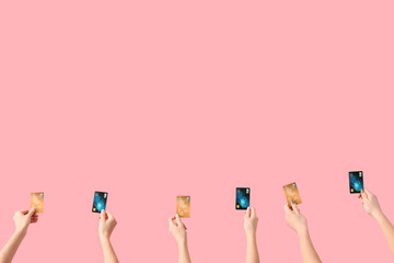 Obraz na płótnie Canvas Women with credit cards on pink background