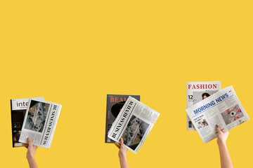 Women with newspapers and magazines on yellow background