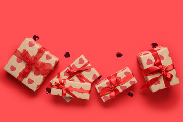 Many gift boxes and confetti on red background. Valentine's Day celebration