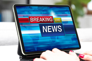 Woman watching breaking news on her tablet