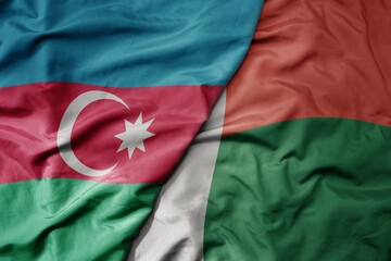 big waving national colorful flag of madagascar and national flag of azerbaijan.
