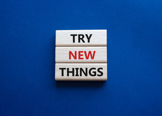 Try new Things symbol. Concept words Try new Things on wooden blocks. Beautiful deep blue background. Business and Try new Things concept. Copy space.