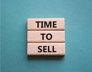 Time to Sell symbol. Concept words Time to Sell on wooden blocks. Beautiful grey green background. Business and Time to Sell concept. Copy space.
