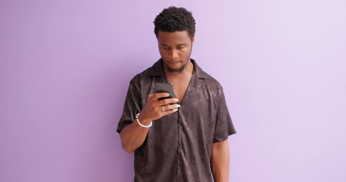 man holding phone, touching screen, taking photo, changing emotions isolated violet background slow motion, bearded man sets up the camera of gadget, making video call, smiling to friend