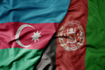 big waving national colorful flag of afghanistan and national flag of azerbaijan.