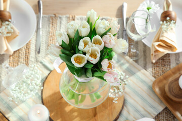 Beautiful tulip flowers on dining table served for International Women's Day celebration