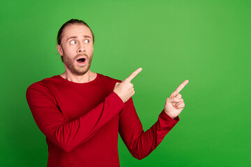 Photo of astonished man with stubble dressed red pullover staring indicating at discount empty...