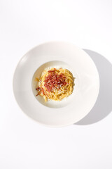 Top View of Classic Italian Carbonara Pasta with Bacon, Cheese, and Egg Yolks, Perfect for High-End Culinary Magazines