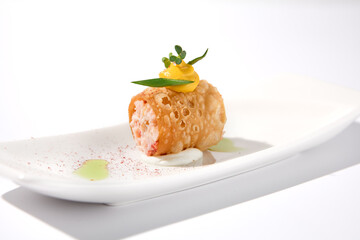 Crunchy crabmeat cannoli on a sleek white dish with a citrus accent, perfect for refined appetizers and modern cuisine
