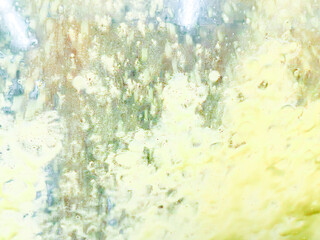 Abstract background flowing in green, yellow, and blue