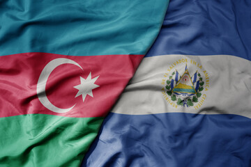 big waving national colorful flag of el salvador and national flag of azerbaijan.