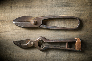 Two old pincers on a wooden table