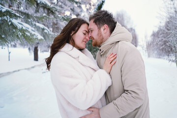 Loving couple on a snowy winter field. Happy together. Happy Valentine's Day