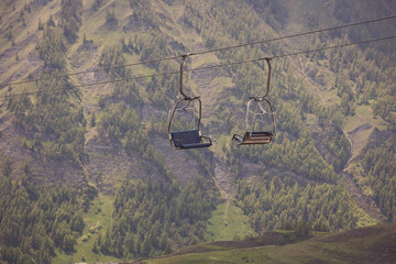 A cable cars one going uphill while one going downhill. Cable Cars On An Alpine Mountainside. Cable...