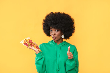Model with an appetizing pizza in her hand.
