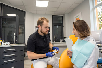 dentist discusses dental problems with a female patient in a dental clinic.
