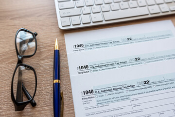 Top view of office desktop wit hfinance document tax form pen keyboard