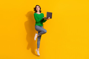 Full body size photo of young girl work using laptop jumping hold laptop shopaholic order xmas...