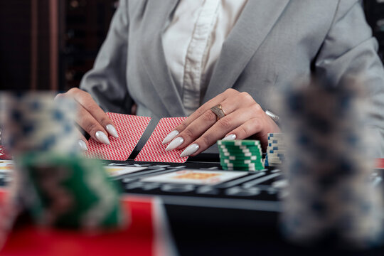 woman play poker at casino. Woman stakes of chips playing in poker