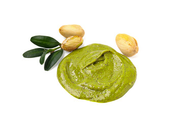Tasty pistachio cream, green leaves and nuts isolated on white