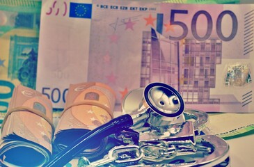 Stethoscope in handcuffs with Euros as background. Medical malpractice concept, corruption,...