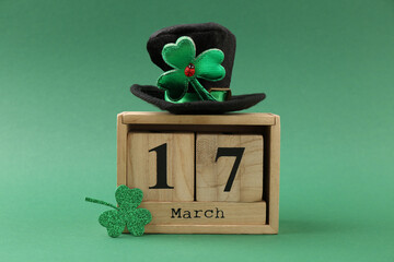 St. Patrick's day - 17th of March. Block calendar, leprechaun hat and decorative clover leaf on...