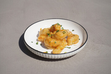 Shrimp in batter on a white plate