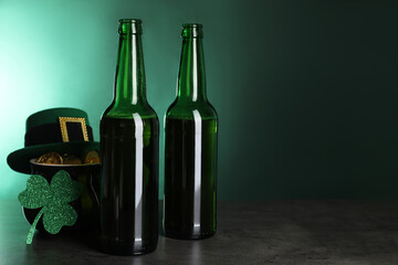 St. Patrick's day celebration. Beer in green bottles, leprechaun hat, pot of gold and decorative...