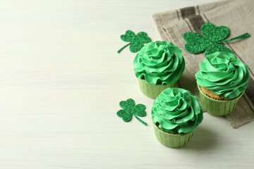 St. Patrick's day party. Tasty cupcakes with green cream on white table. Space for text