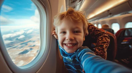 Selbstklebende Fototapete Alte Flugzeuge Little boy play with toy plane in the commercial jet airplane flying on vacation