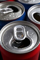 Energy drinks in wet cans as background, closeup. Functional beverage