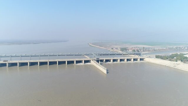 Aerial view of Head Taunsa Barrage is a barrage on the Indus River in Tehsil Taunsa, Dera Ghazi Khan District, Punjab Province, Pakistan. Where a lot of water is stored. Beautiful drone 4K view.