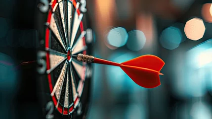 Tuinposter red dart hitting the center of bulls eye. Business target or goal success and winner concept © Ilmi