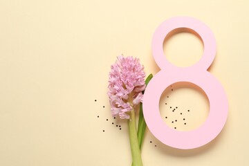 8th of March greeting card design with paper number eight, beautiful flowers and space for text on beige background, flat lay. International Women's day