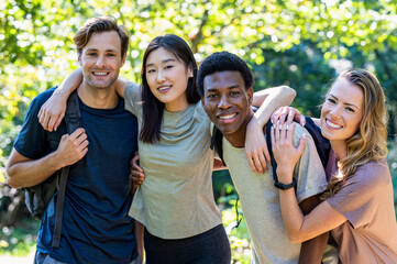 Portrait of small group of friends looking at the camera during hiking excursion