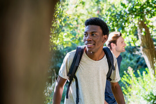 Young adult man wearing backpack during hiking with friends
