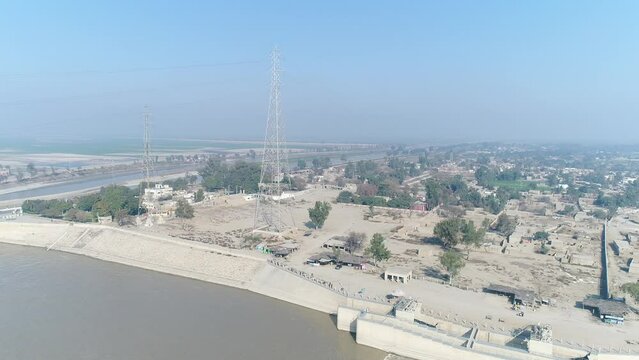 Aerial view of Head Taunsa Barrage is a barrage on the Indus River in Tehsil Taunsa, Dera Ghazi Khan District, Punjab Province, Pakistan. Where a lot of water is stored. Beautiful drone 4K view.