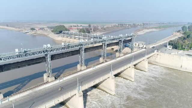 Aerial view of Head Taunsa Barrage is a barrage on the Indus River in Tehsil Taunsa, Dera Ghazi Khan District, Punjab Province, Pakistan. Where a lot of water is stored. Beautiful drone 4K view.