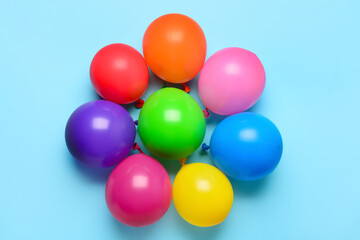 Composition with colorful festive balloons on blue background