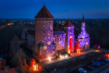 The Teutonic castle in Reszel in Warmia illuminated at dusk, Poland. - Powered by Adobe
