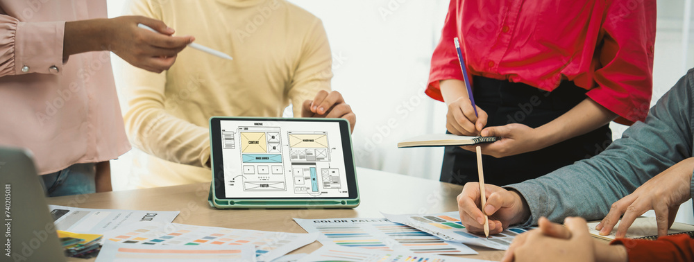 Poster cropped image of interior designer team discuss the material color while tablet displayed website wi