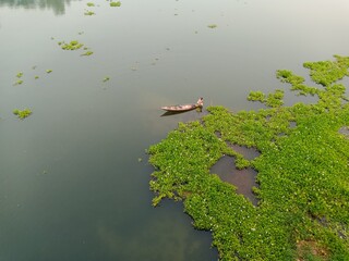fishing on boat in river, rural village of Bangladesh