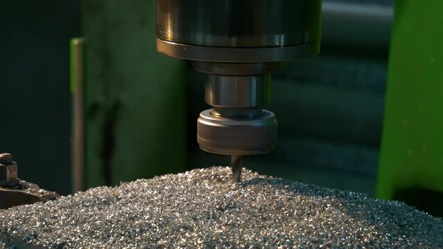 Turners and millers work at machines. The machines are turning out parts. Milling and lathe machines in a workshop in a factory.