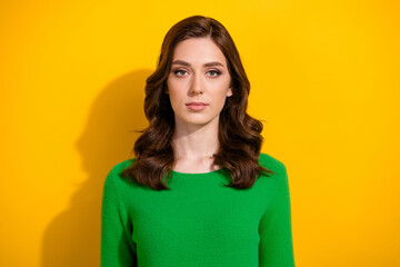 Obraz premium Photo of stunning focused concentrated girl calm face wavy hairdo isolated on yellow color background