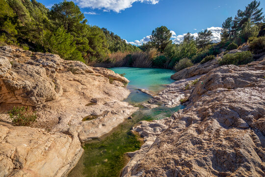Horizontal photo of the source of Fuente Caputa, between rocks, in the town of Mula, Region of Murcia, Spain, between rocks and on a sunny day