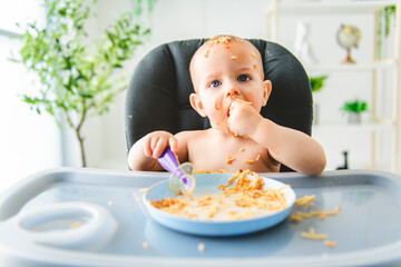 Little baby eating her dinner and making a mess