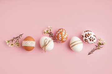 Decorated Easter eggs with small flowers on pink background - obrazy, fototapety, plakaty