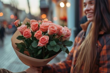 Fototapeta premium A person stands among a vibrant array of garden roses, carefully arranging them into a beautiful bouquet in a red vase, their clothing adorned with delicate petals and their face beaming with the joy