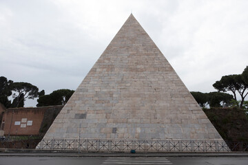 Fototapeta na wymiar Italy Rome Pyramid of Cestius on a cloudy spring day